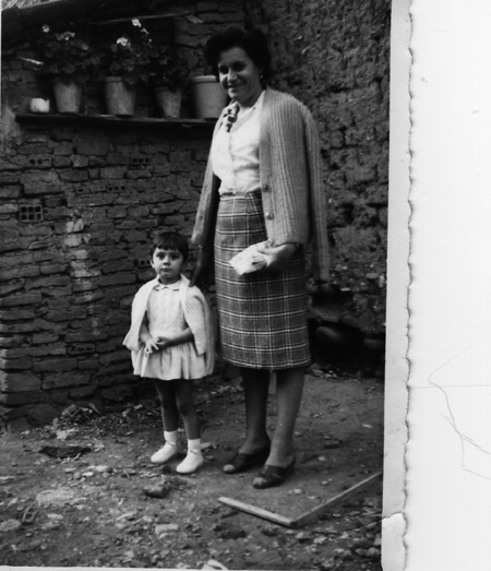 Mujer y niÃ±a con macetas de fondo. Torralba de los Sisones