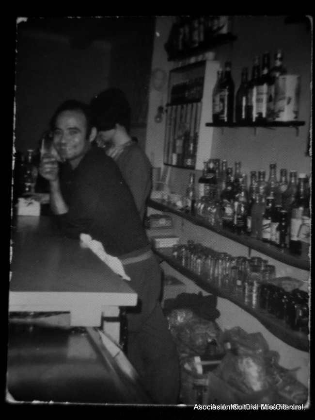 Hombre dentro de la barra de un bar